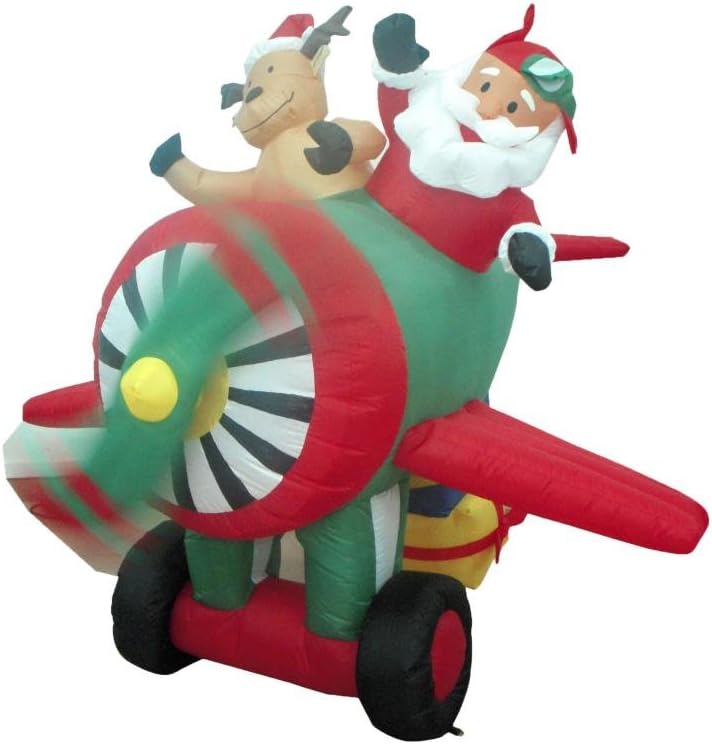 Santa in pilot goggles flying a red and green propeller plane with a reindeer passenger