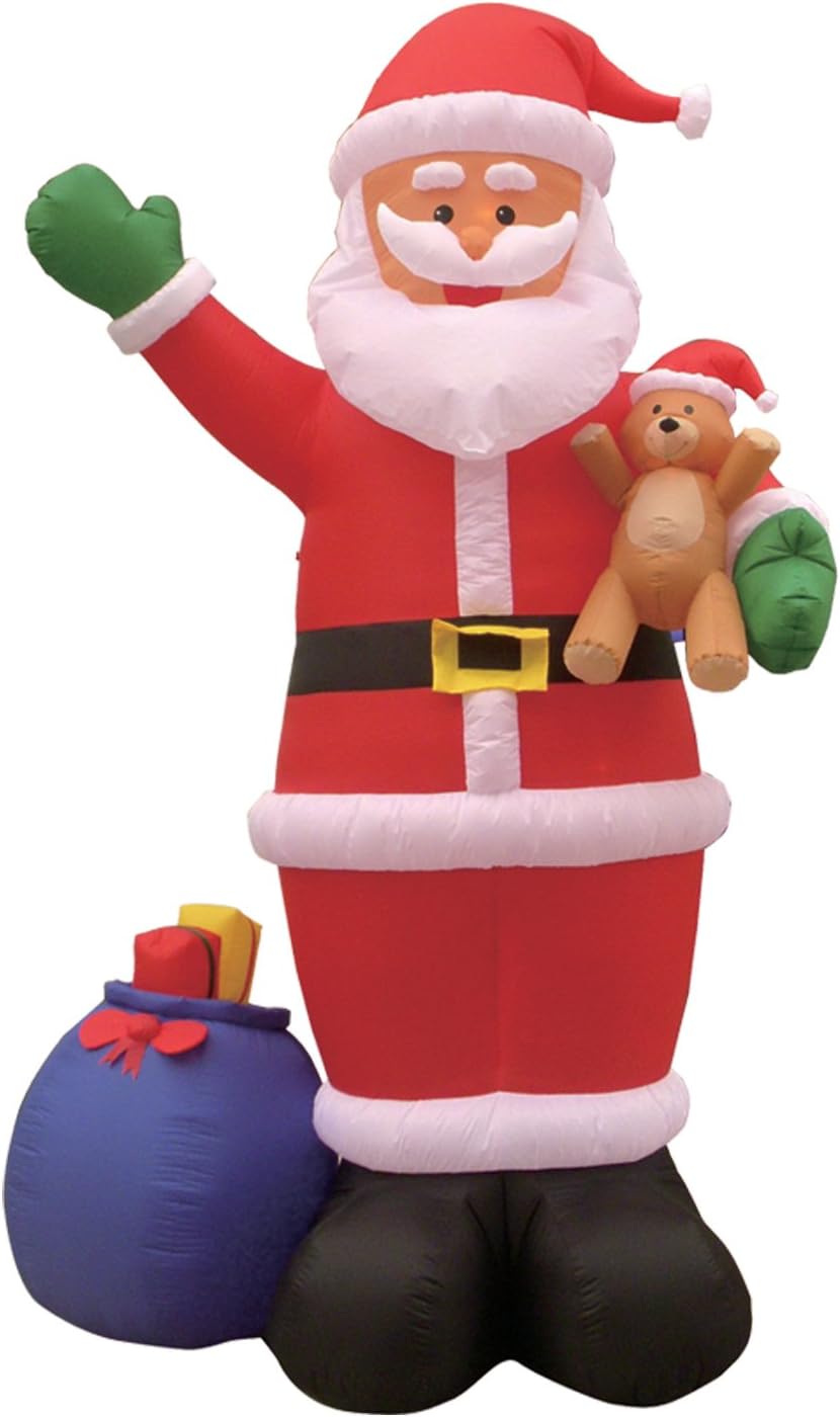 Giant Santa inflatable waving and holding a teddy bear with a blue gift sack at his feet