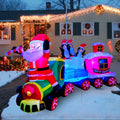 Lighted Christmas train inflatable with Santa driving and penguins in the cars in a snowy yard