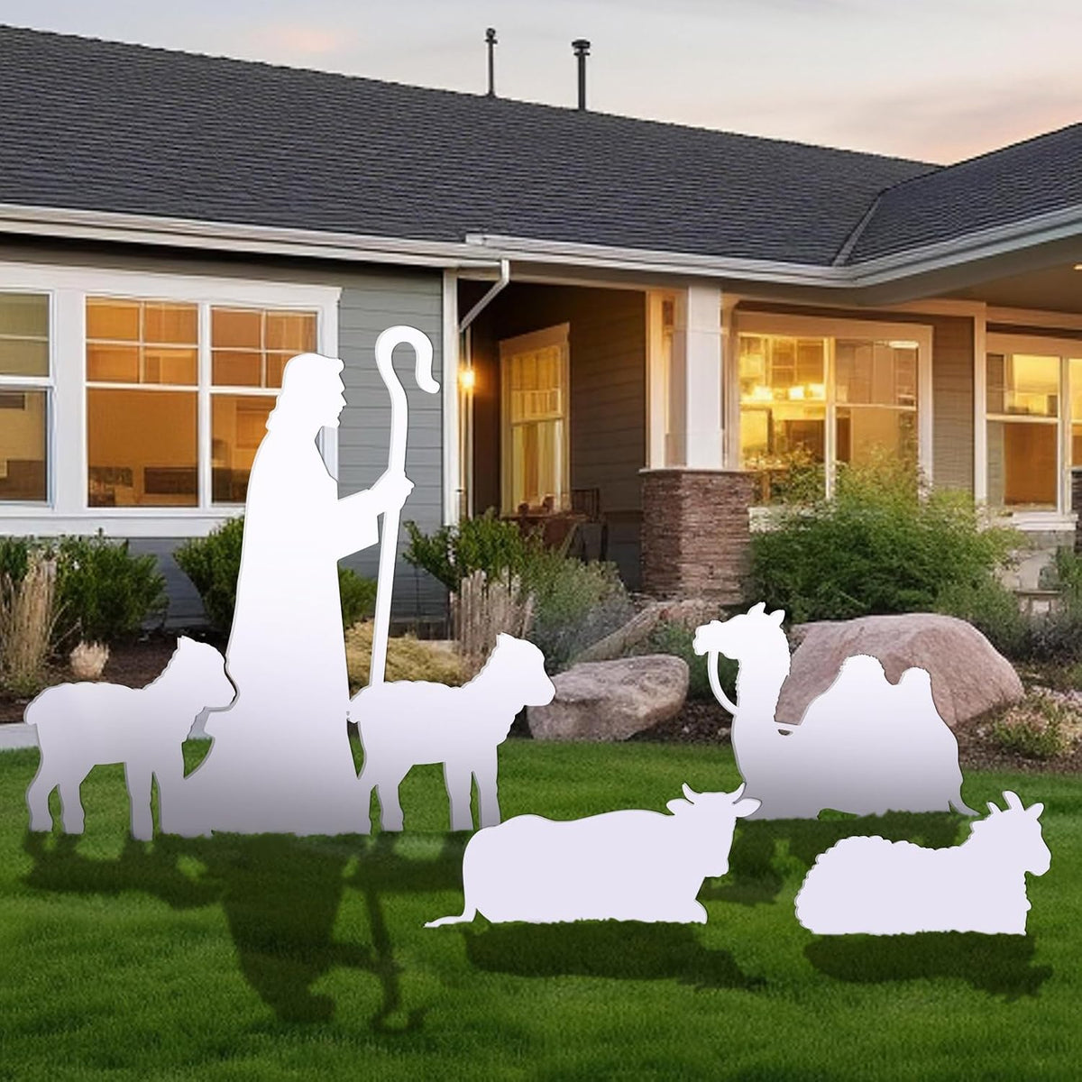 White silhouette shepherd with staff, sheep and a camel standing on a front lawn