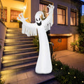 Tall white ghost inflatable with raised ragged arms beside a front staircase at dusk