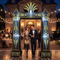 Black and gold Art Deco inflatable arch with a fan crest at a 1920s themed party entrance