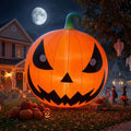 Giant glowing jack-o'-lantern inflatable with a toothy grin in a yard under a full moon