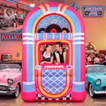 Pink and blue jukebox inflatable with a couple posing in the photo window at a 50s diner party