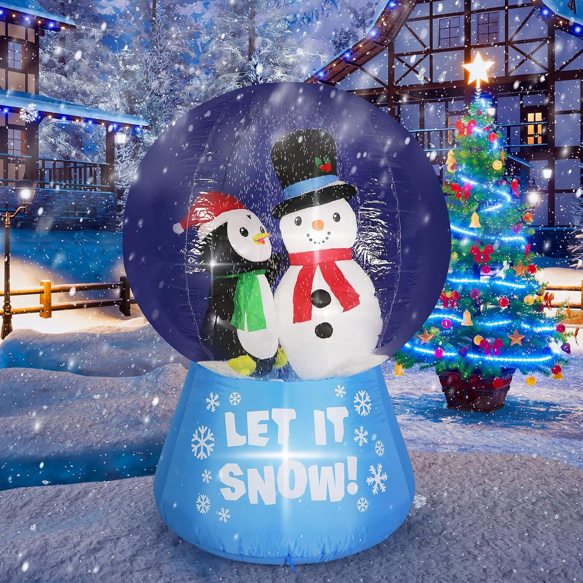 Inflatable snow globe with a snowman and penguin inside on a blue Let It Snow base in a snowy yard