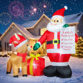 Santa inflatable holding a Nice List beside a reindeer in a Santa hat and a red gift in the snow