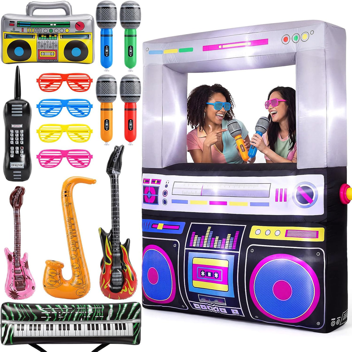 Giant boombox photo booth inflatable with two women posing, plus inflatable guitars, saxophone and sunglasses props