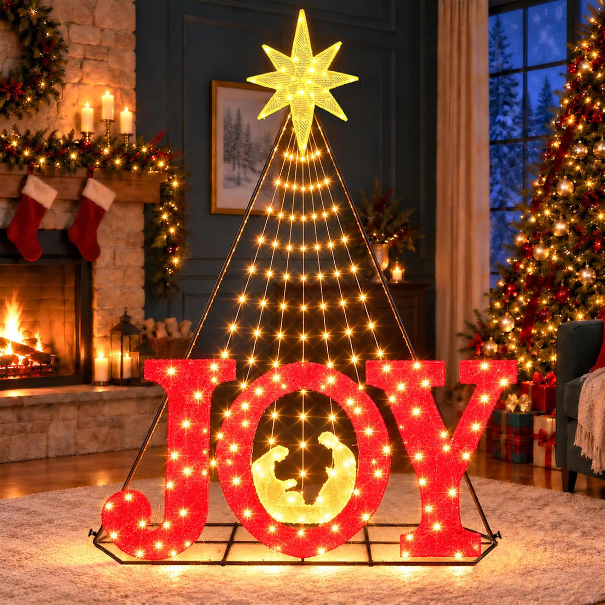 Red lighted JOY letters with a nativity silhouette under a cone of yellow lights with a star