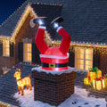Santa legs and boots sticking out of a brick chimney inflatable on a snowy roof