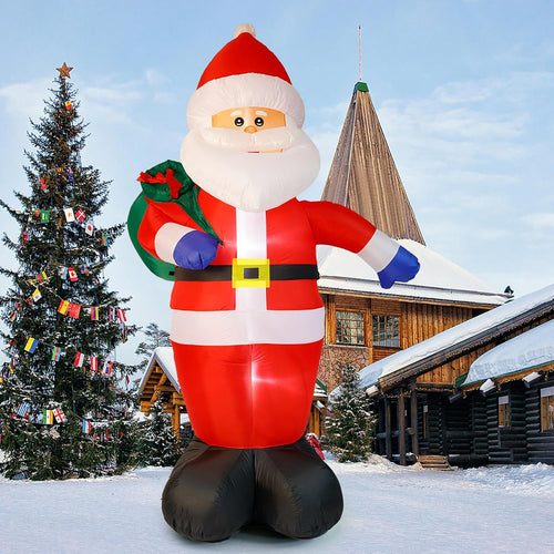 Giant Santa inflatable with open arms and a green gift sack in a snowy yard