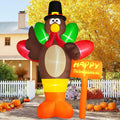 Tall turkey inflatable in a pilgrim hat beside a Happy Thanksgiving street sign in a fall yard
